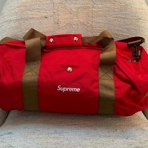 Supreme red duffel bag.
